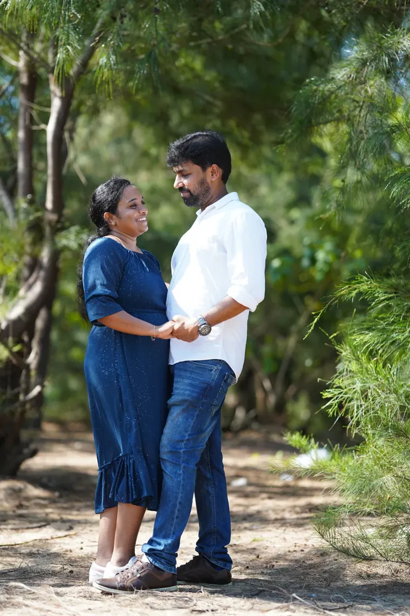 Couple holding hands under the trees