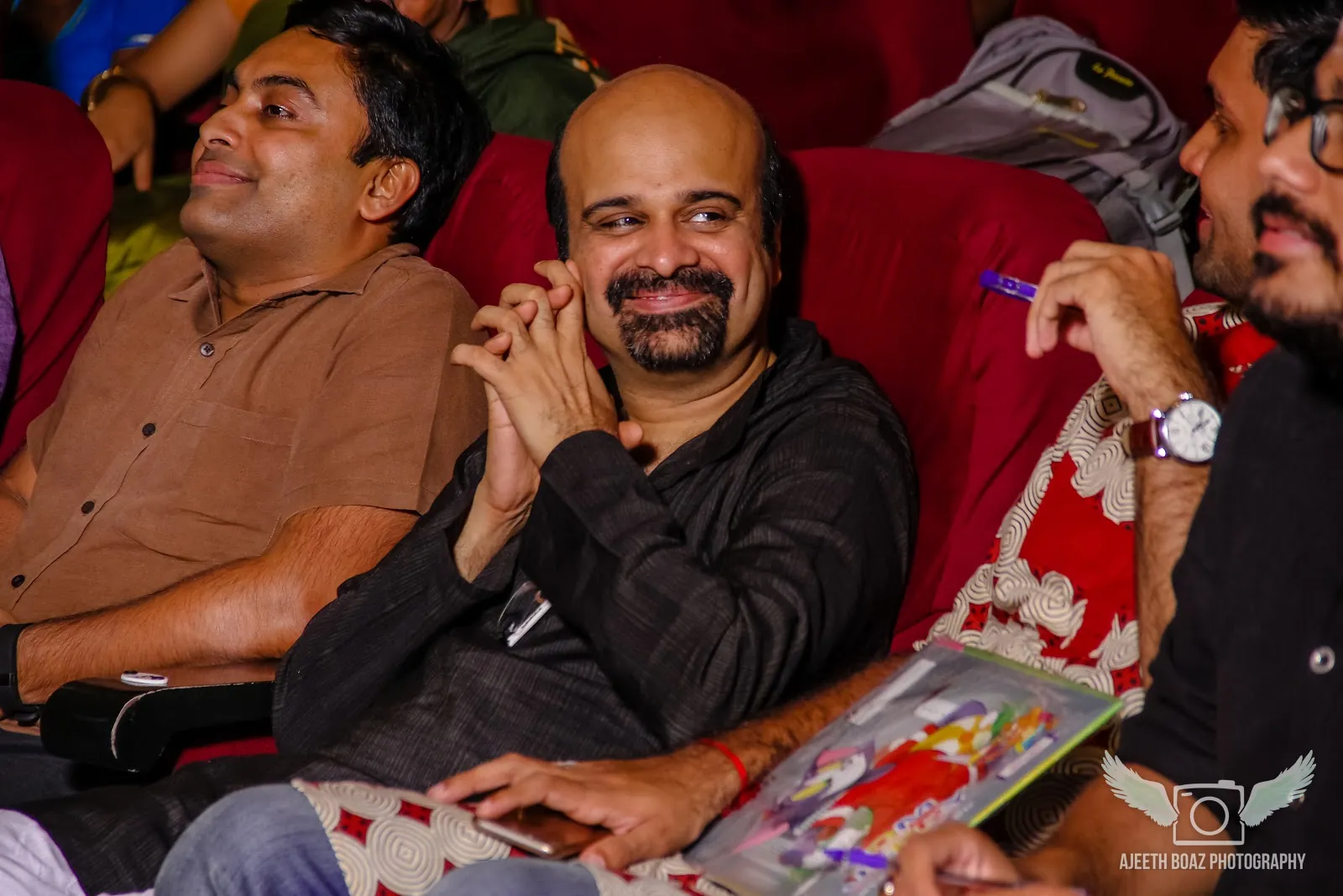 Audience members smiling at a live event — concert and event photography by Ajeeth Boaz Photography, Chennai